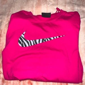 pink nike shirt with zebra print nike sign